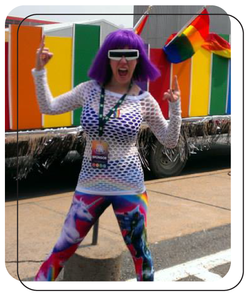 Alison Knott in purple wig, big glasses and rainbow tights outside during Halifax Pride.