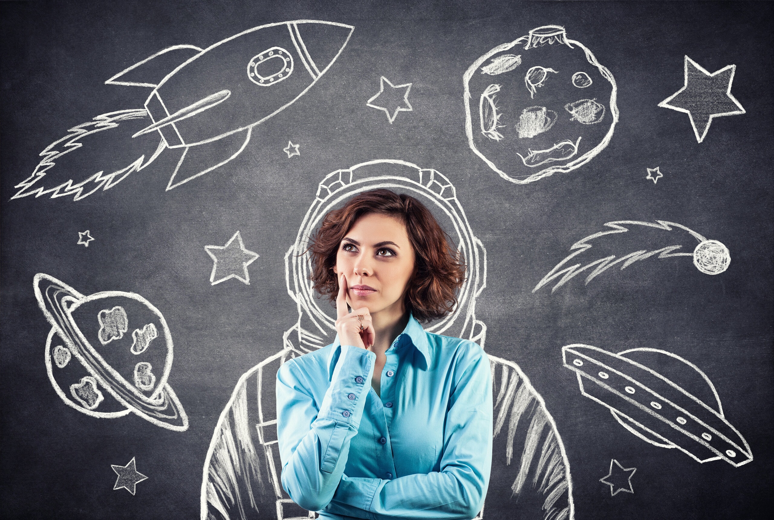 Woman thinking about her business goals, as imagery of space and rocketships are drawn around her.